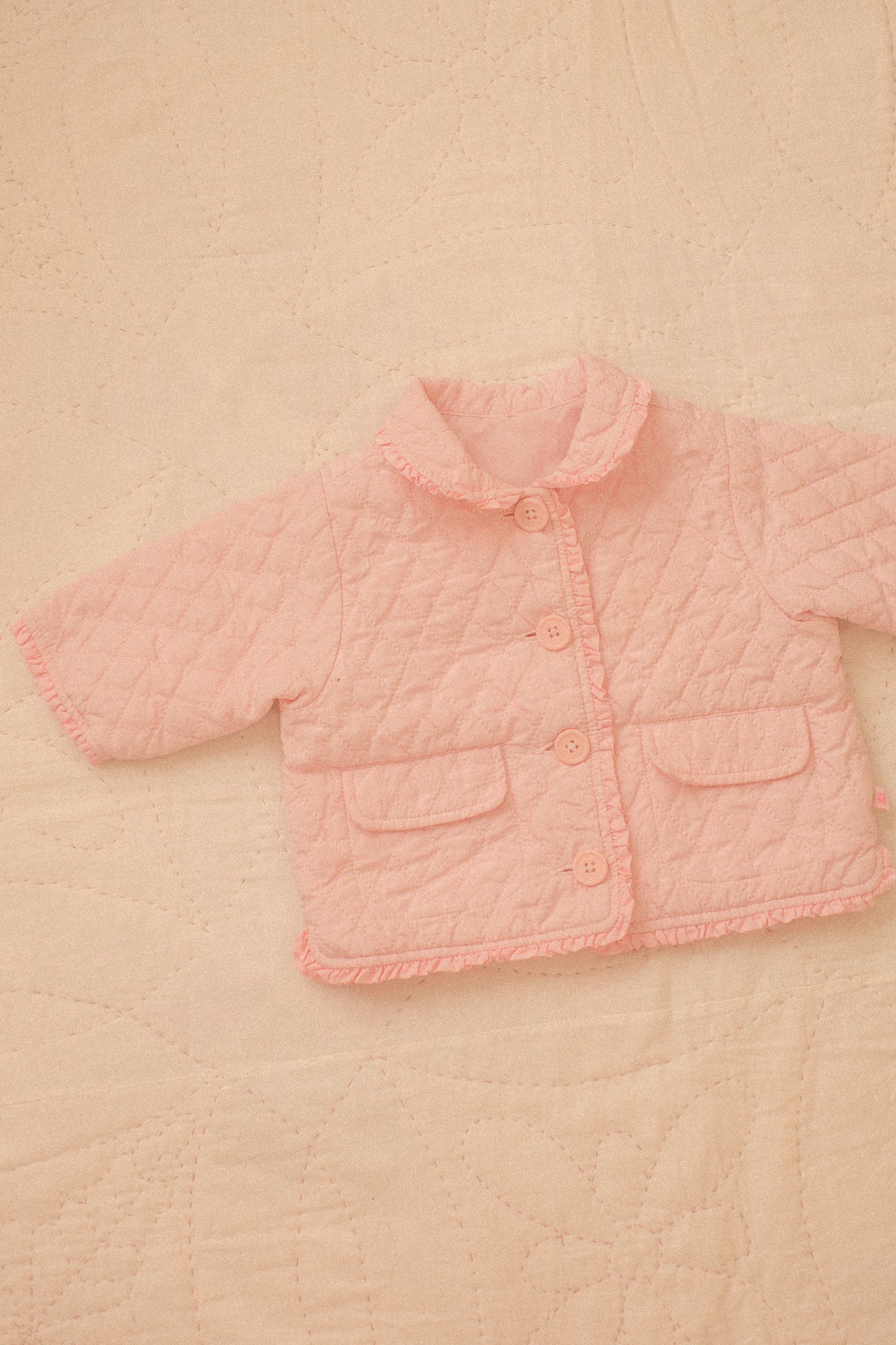 Quilted pink ruffled baby jacket