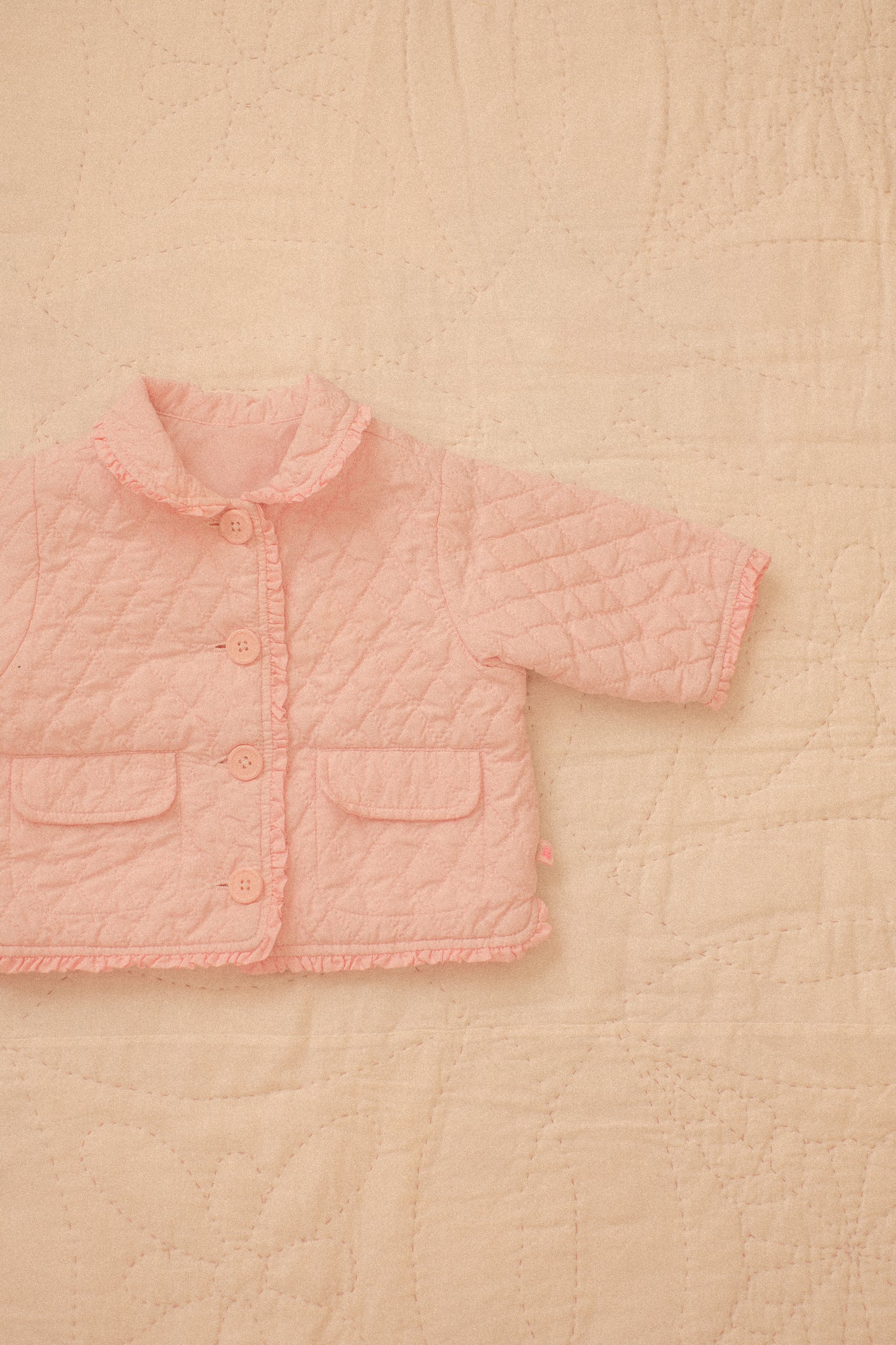 Quilted pink ruffled baby jacket