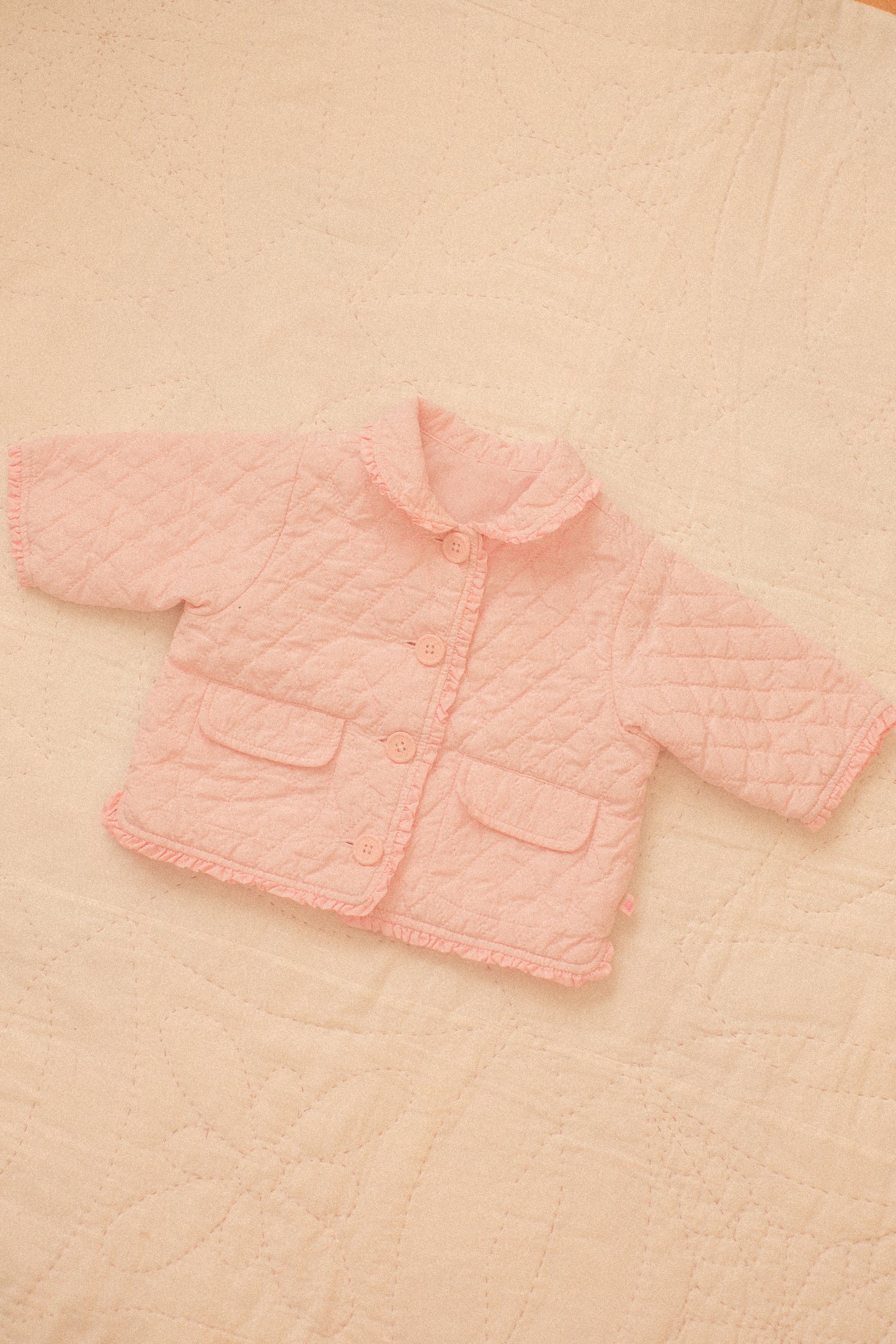 Quilted pink ruffled baby jacket