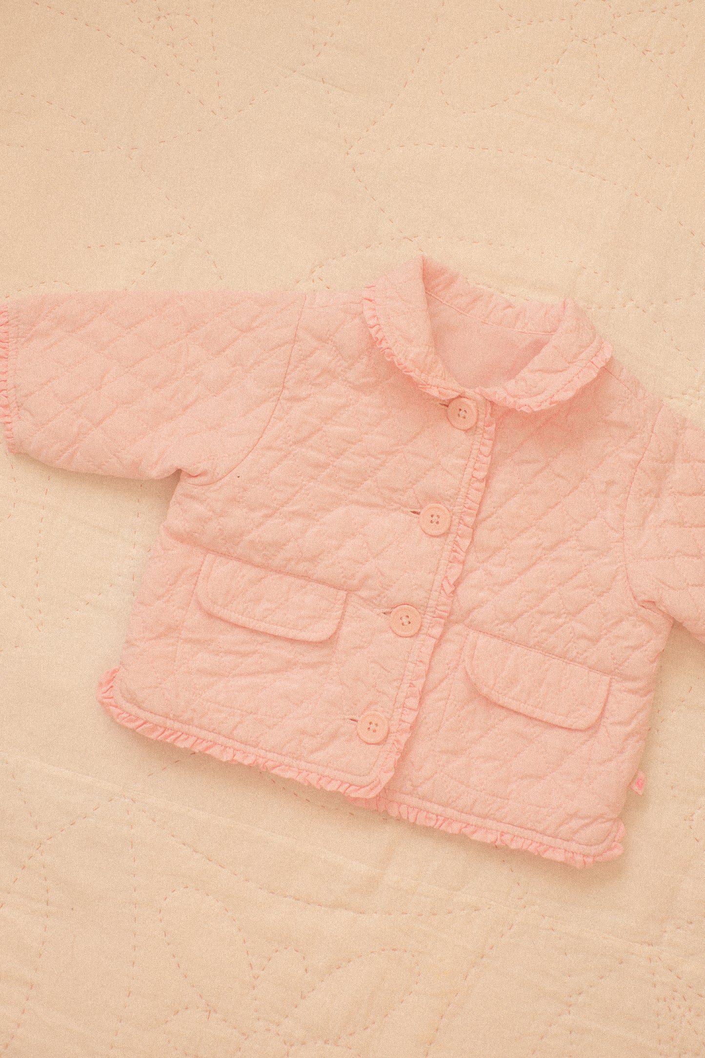 Quilted pink ruffled baby jacket