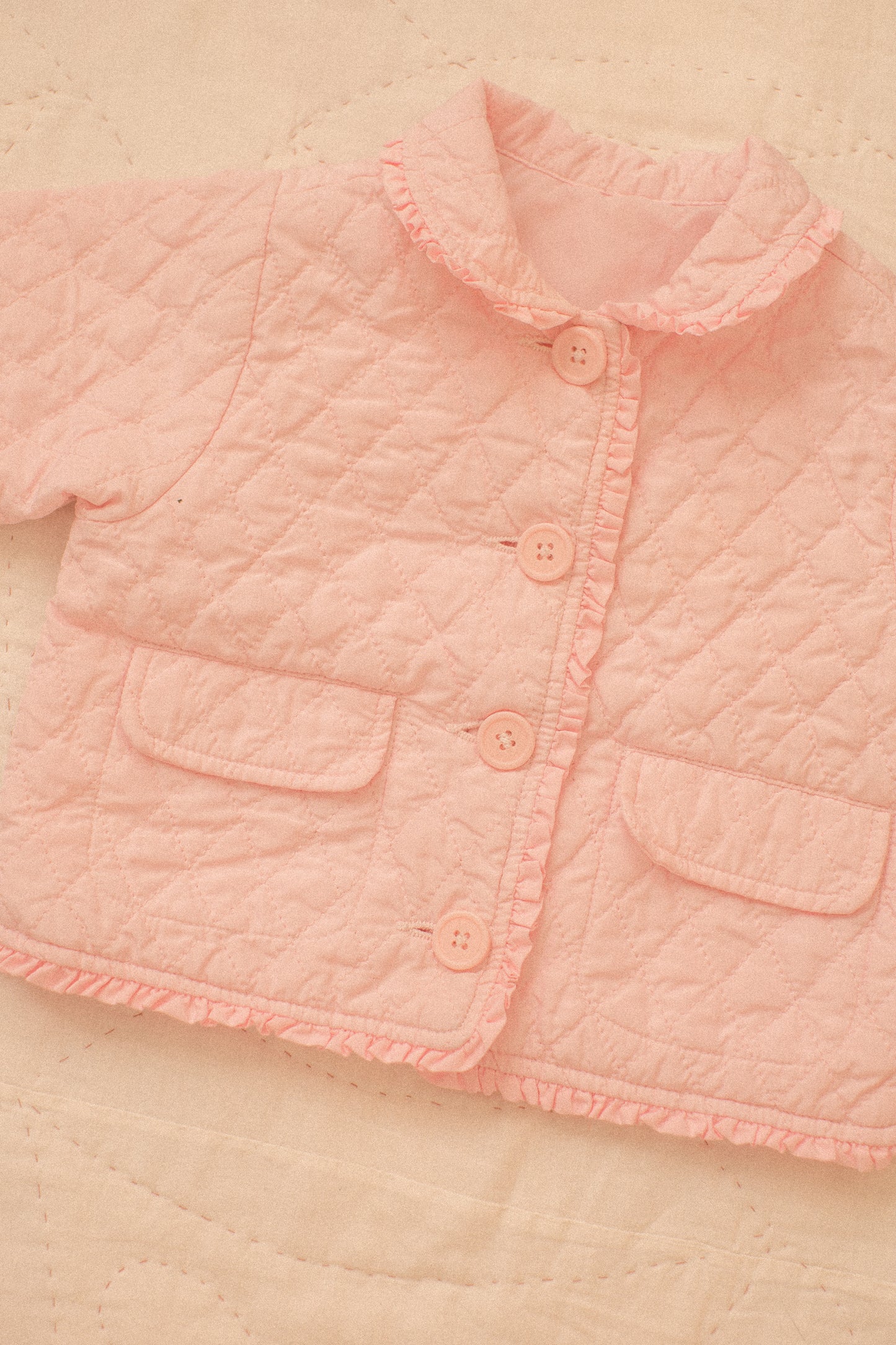 Quilted pink ruffled baby jacket
