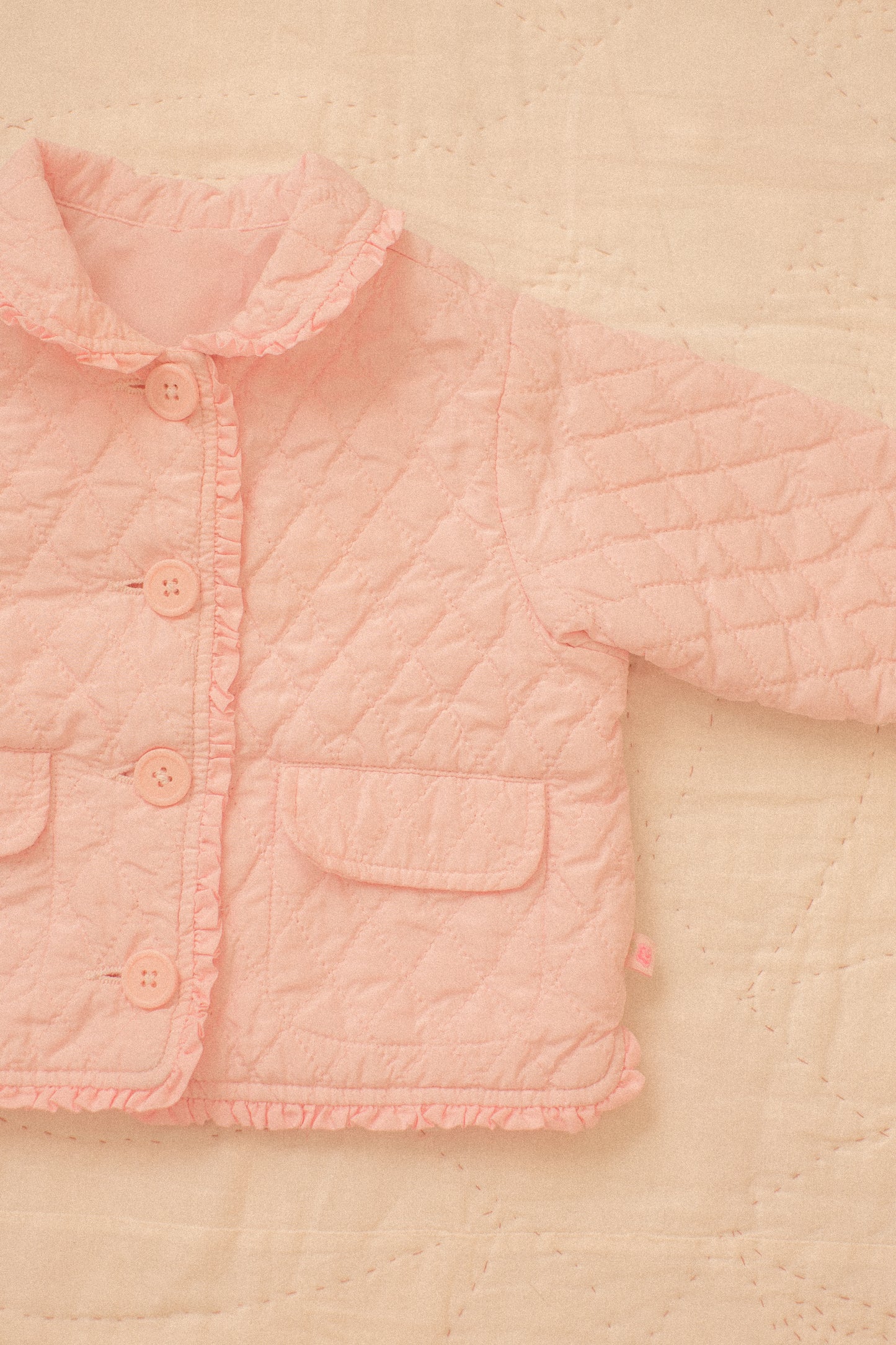 Quilted pink ruffled baby jacket