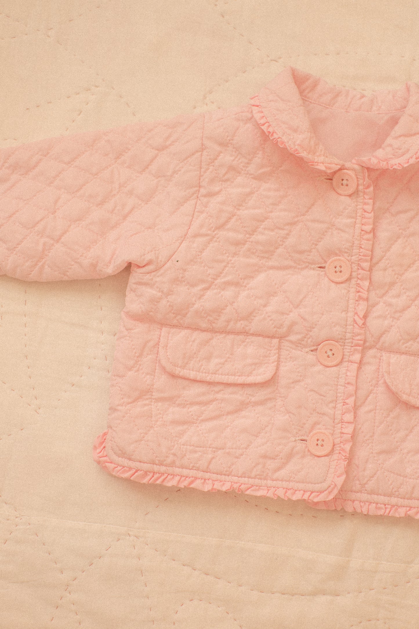 Quilted pink ruffled baby jacket