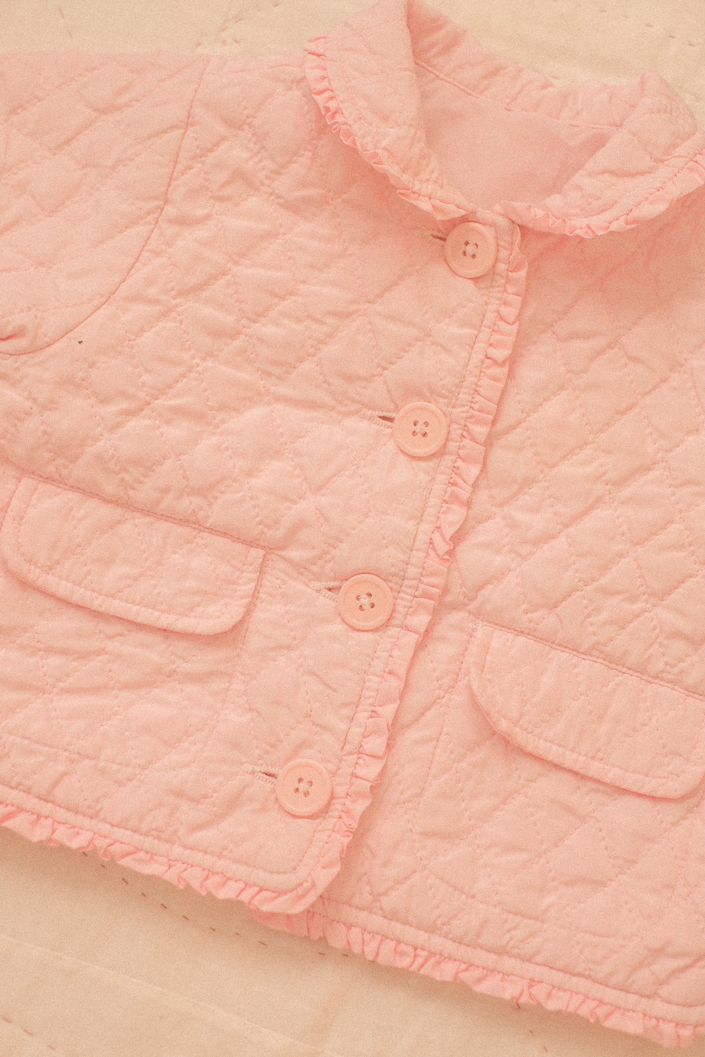 Quilted pink ruffled baby jacket