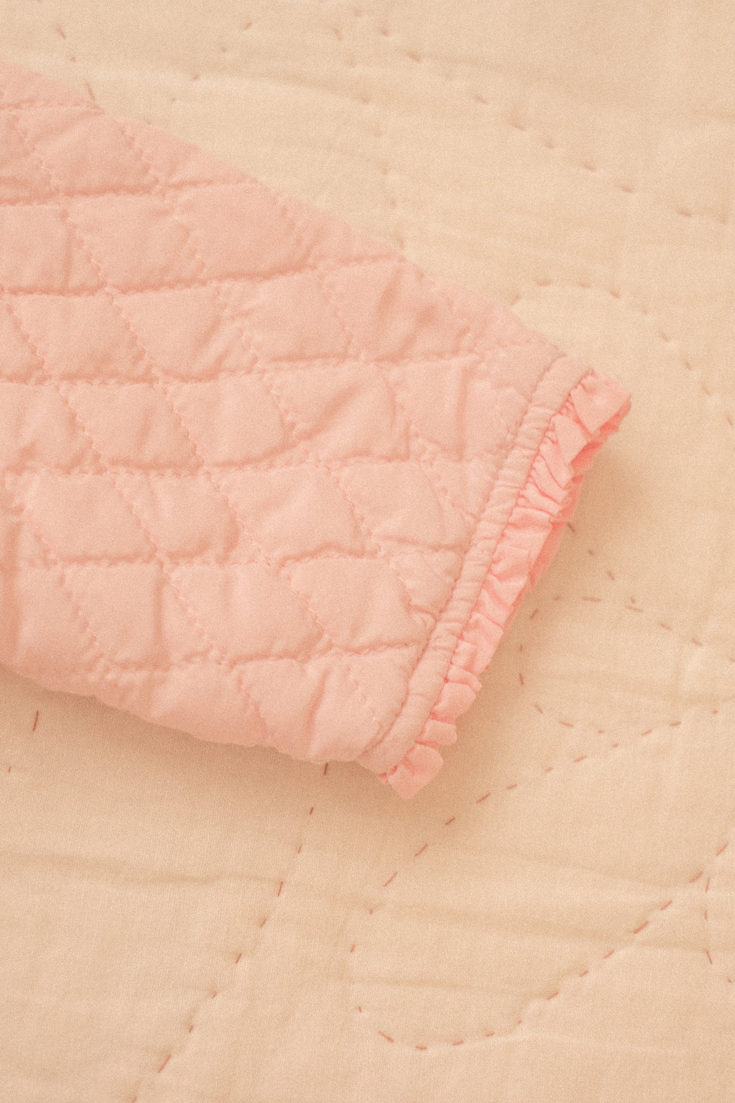 Quilted pink ruffled baby jacket
